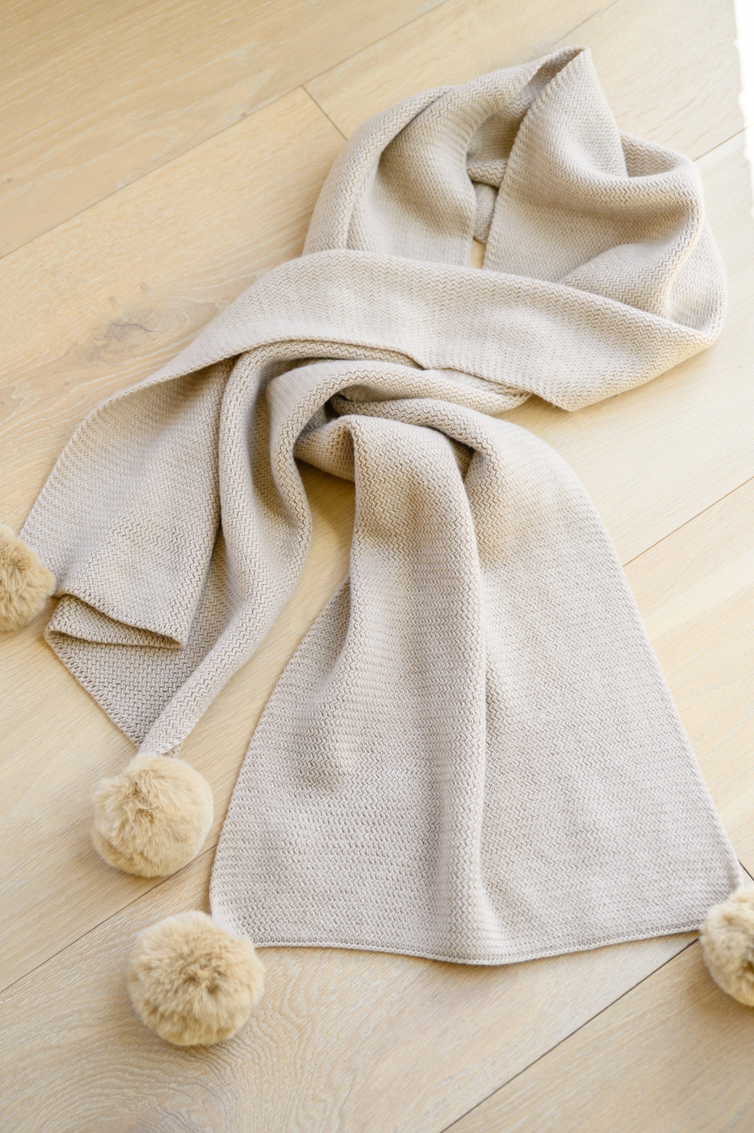 Warm Fuzzies Knitted Pom Pom Scarf In Beige
